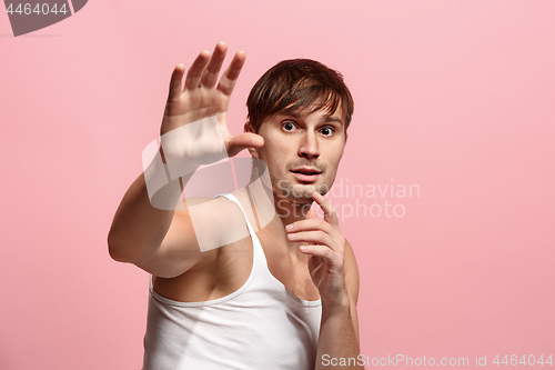 Image of Portrait of the scared man on pink