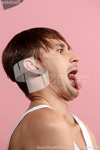 Image of The squint eyed man with weird expression isolated on pink