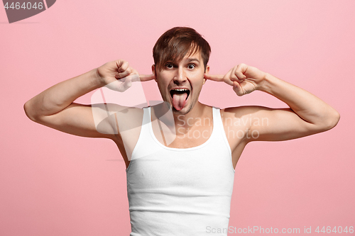 Image of The squint eyed man with weird expression isolated on pink