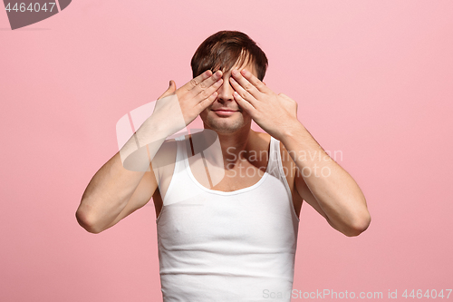 Image of Portrait of the scared man on pink