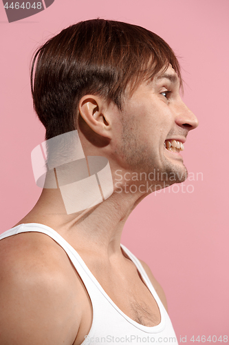 Image of Handsome man looking suprised isolated on pink