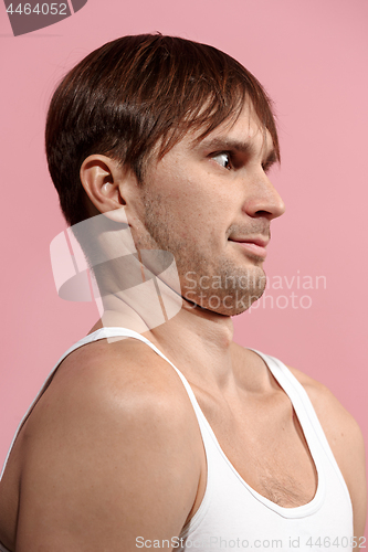 Image of Handsome man looking suprised isolated on pink