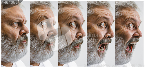 Image of The senior attractive man looking suprised isolated on white