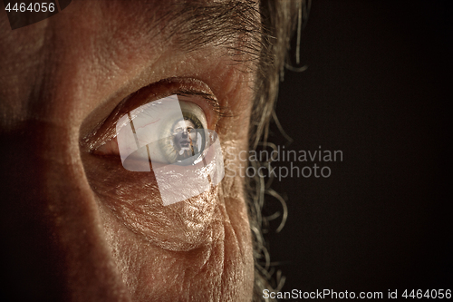 Image of Half face of aggressive man looking with hatred into camera, domestic tyrant