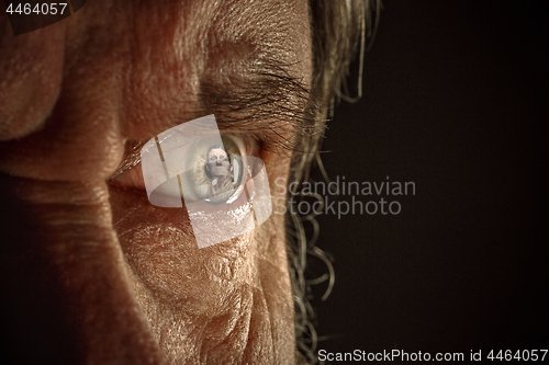 Image of Half face of aggressive man looking with hatred into camera, domestic tyrant