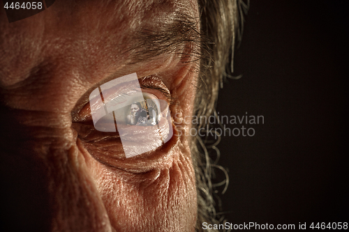 Image of Half face of aggressive man looking with hatred into camera, domestic tyrant