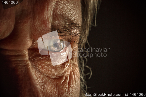 Image of Half face of aggressive man looking with hatred into camera, domestic tyrant