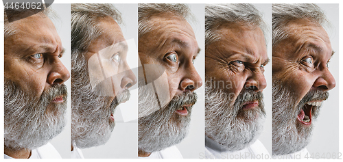 Image of The senior attractive man looking suprised isolated on white