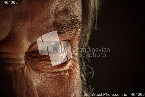 Image of Half face of aggressive man looking with hatred into camera, domestic tyrant