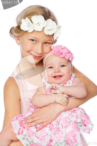 Image of happy beautiful girl with baby baby sister