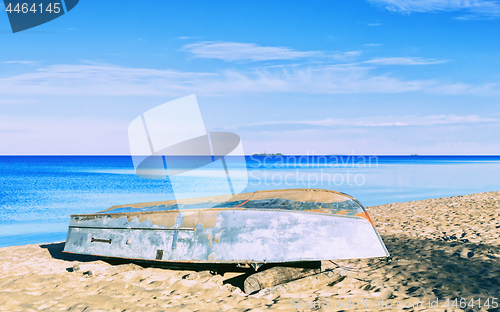 Image of Boat On A Sandy Shore Under A beautiful Blue Sky