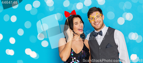 Image of happy couple with party props having fun