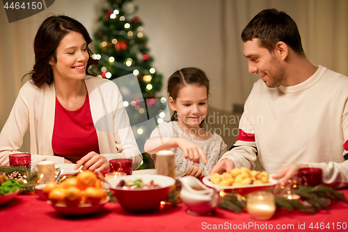 Image of happy family having christmas dinner at home