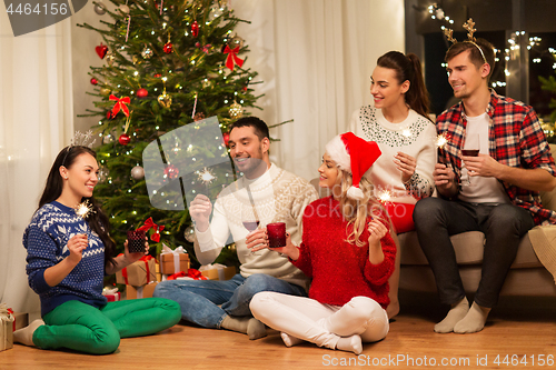 Image of friends with sparklers celebrating christmas