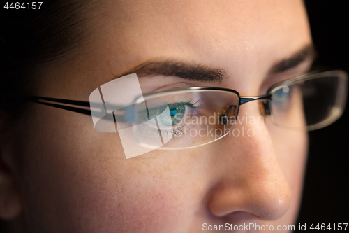 Image of close up of woman in glasses looking at screen