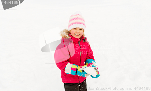 Image of happy little girl playing with snow in winter
