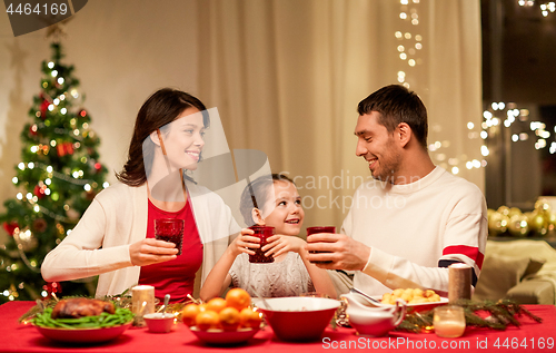 Image of happy family having christmas dinner at home