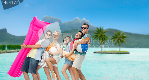 Image of friends with beach accessories over bora bora