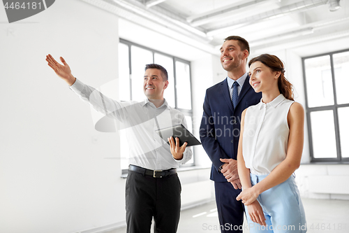 Image of realtor with tablet pc showing office to customers