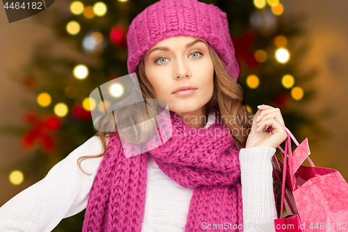 Image of woman with shopping bags over christmas lights