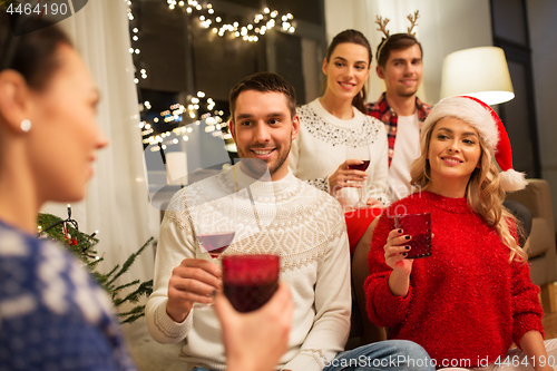 Image of friends celebrating christmas and drinking wine