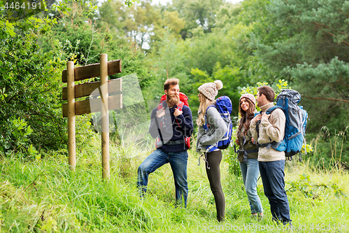 Image of hiking friends with backpacks at signpost