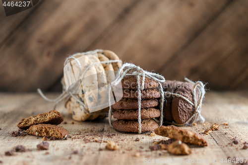 Image of shortbread, oat cookies, chocolate chip biscuit on wooden background.