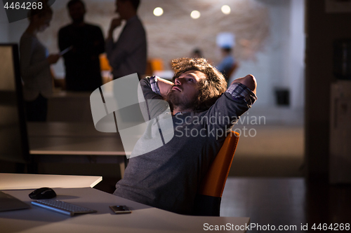 Image of businessman relaxing at the desk