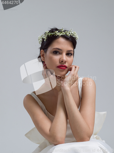 Image of young bride sitting in a wedding dress