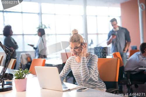 Image of businesswoman using a laptop in startup office