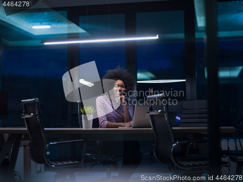 Image of black businesswoman using a laptop in startup office