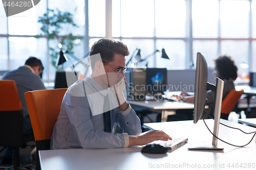 Image of businessman working using a computer in startup office