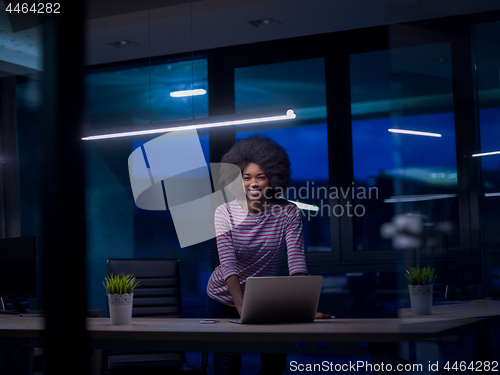 Image of black businesswoman using a laptop in startup office