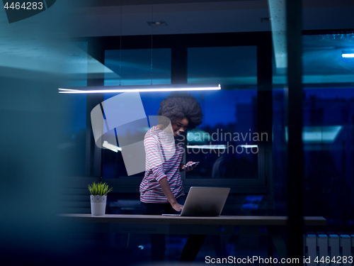 Image of black businesswoman using a laptop in startup office