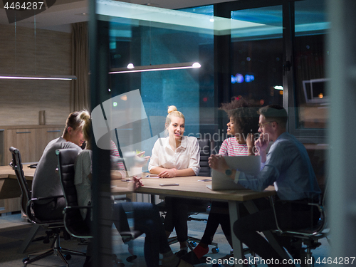 Image of Multiethnic startup business team in night office