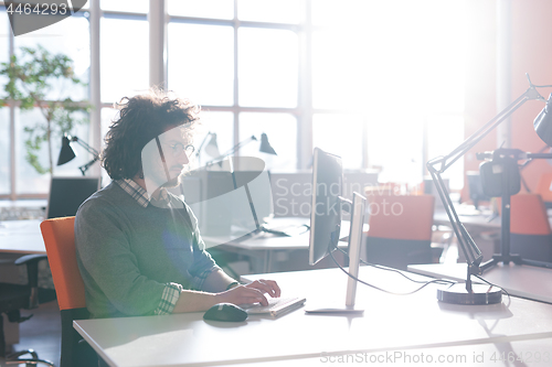 Image of businessman working using a computer in startup office