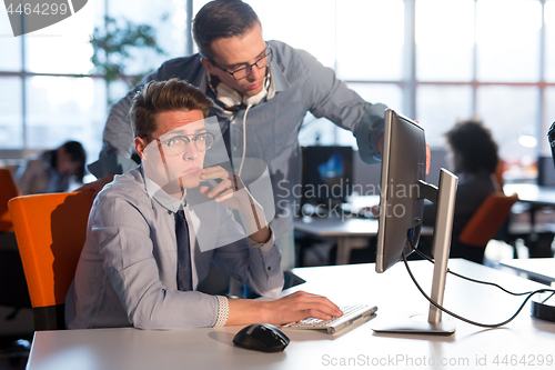 Image of Two Business People Working With computer in office