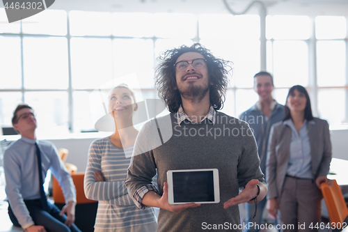 Image of Portrait of a young businessman holding tablet