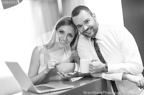 Image of A young couple is preparing for a job and using a laptop