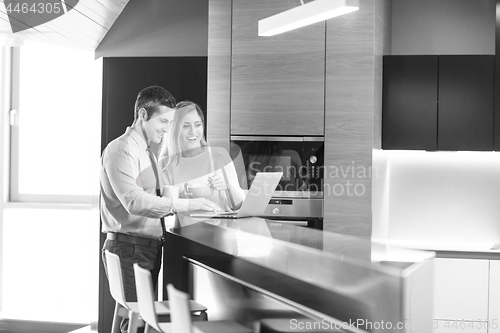 Image of A young couple is preparing for a job and using a laptop