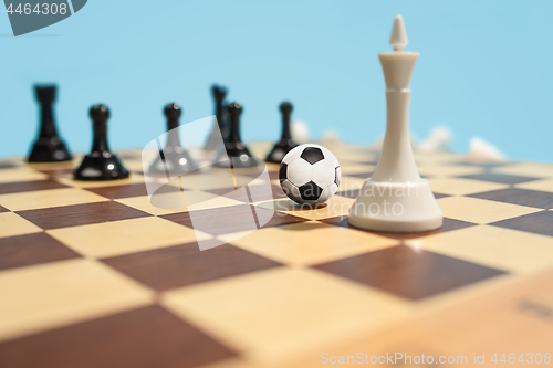 Image of soccer ball of chess pieces on the board