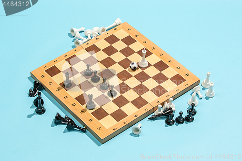 Image of soccer ball of chess pieces on the board
