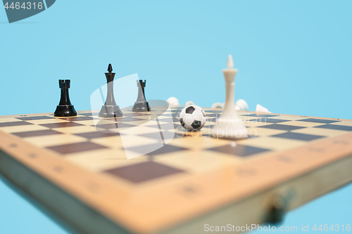 Image of soccer ball of chess pieces on the board