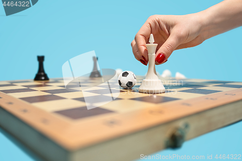 Image of soccer ball of chess pieces on the board