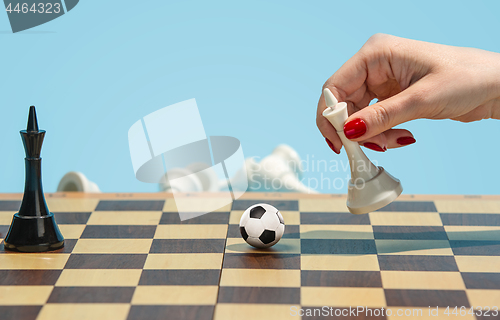Image of soccer ball of chess pieces on the board