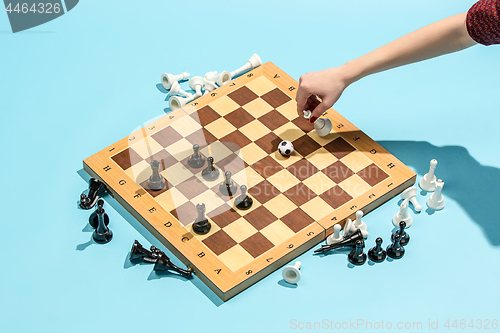 Image of soccer ball of chess pieces on the board