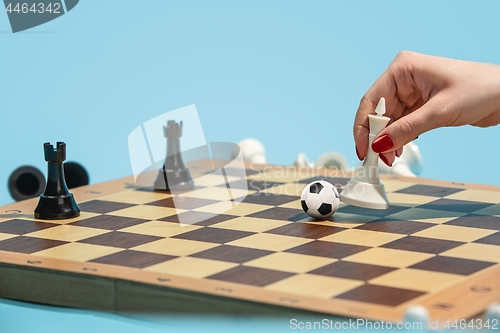 Image of soccer ball of chess pieces on the board