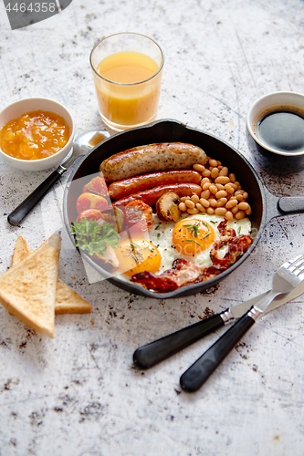 Image of Full English breakfast on bright rusty background