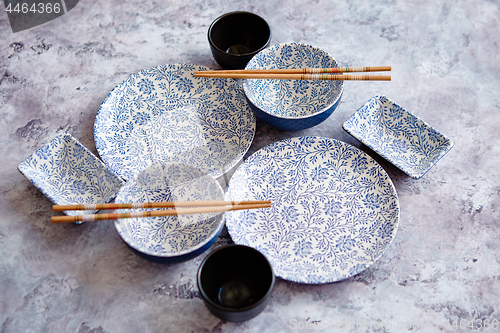 Image of Empty oriental style dishware set on gray stone background