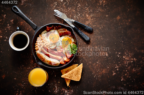 Image of Delicious english breakfast in iron cooking pan